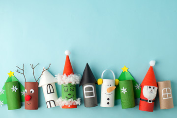Paper toy Santa, Snowman, Grinch for Xmas party. Easy crafts for kids on blue background, copy space, die creative idea from toilet tube roll, recycle reuse eco concept - 303485939
