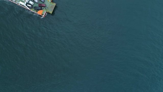 Aerial view from above to Kotor Bay and regular ferry for cars and passengers from Lepetane to Kamenari