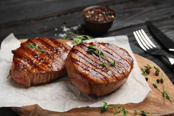 Delicious grilled beef medallions served on table, closeup