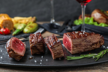 Delicious sliced beef steak served on table, closeup