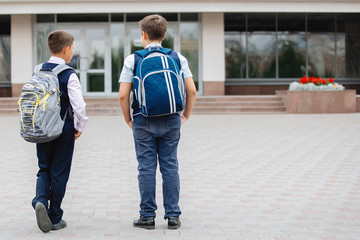 Two teenagers in school uniforms.