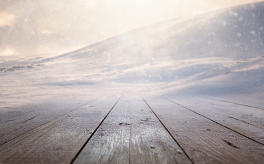 Snowy wooden table background in scenic snowy mountains