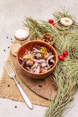 Fototapeta na wymiar Pickled (fermented) mushrooms. Traditional New Year (Christmas) snack. Festive table cutlery setting