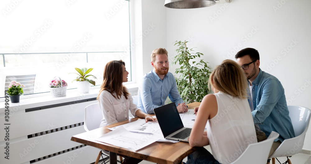 Wall mural Group of architects and business people working together and brainstorming