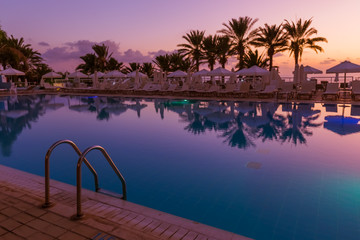 Fototapeta na wymiar Swimming pool on Cyprus island at sunset