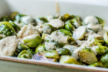 Cooked Brussel Sprouts with Milk Cream Sauce on Porcelain Bowl.