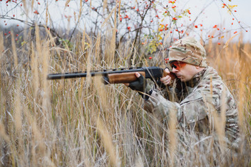 Fototapeta premium Hunting permit. Man brutal gamekeeper nature background. hunter spend leisure hunting. Hunter hold riffles. Focus and concentration of experienced hunter. Hunting and trapping seasons.