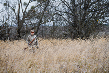 The hunter takes aim at the wild beast in the forest. Hunting concept