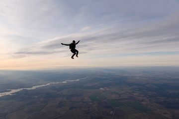 Skydiving. A solo skydiver is flying in the sky