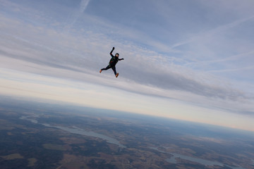 Fototapeta na wymiar Skydiving. A solo skydiver is flying in the sky