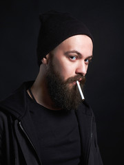 handsome bearded smoking man in Hat