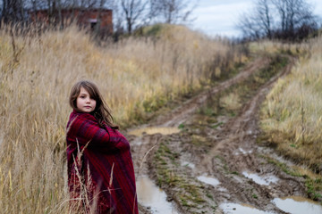 beautiful girl with a handkerchief near the mud