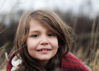 beautiful girl with warm shawl in autumn field