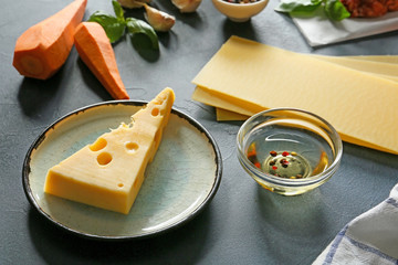 Ingredients for lasagna on dark background