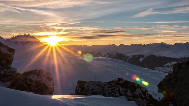 4k timelapse of a sunrise over the mountains in the Swiss Alps during the winter. 