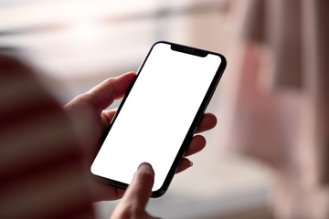 Woman touching on screen and holding blank screen mock up mobile phone