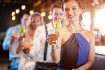 Friends having a good time with cocktails in a bar