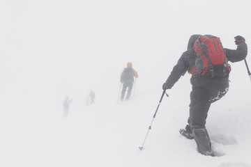 tourists in a bad weather in the mountains