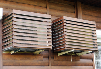 The air conditioner installed on the street is protected by a metal casing.