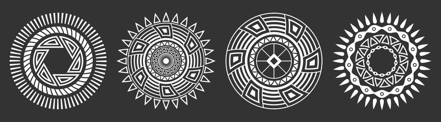 Set of four abstract circular ornaments. Decorative patterns isolated on black background. Tribal ethnic motifs. Stylized sun symbols. Stencil tattoo and prints Vector monochrome illustration.