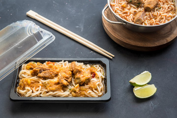  noodles chicken with vegetable in black background