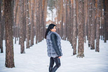 Fototapeta na wymiar Winter holidays concept. Arabic woman in stylish look at snowy day outside