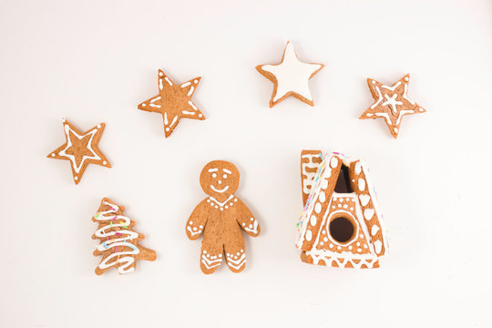 Gingerbread gingerbread in the form of a man, a house, a Christmas tree on a light background.