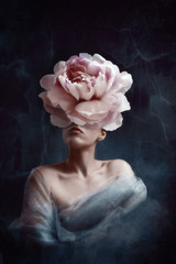 Strange fine art concept. The body of a woman, her head is a peony