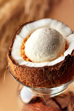 Ice cream with nuts and lemon sauce in halved coconut.