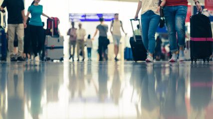 Scene of traveller with luggage reflection on floor in airport during busy hour