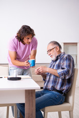 Young student and his old grandpa at home