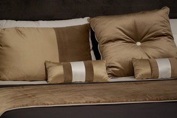 beautiful comfortable brown pillows on the bed in the bedroom