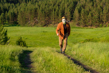 running at us a man in a gas mask jacket in the hands of a sword