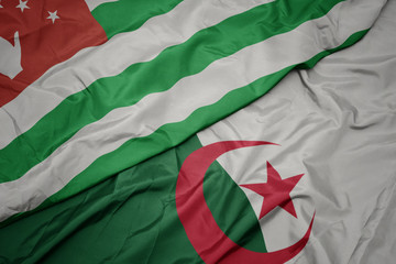 waving colorful flag of algeria and national flag of abkhazia.
