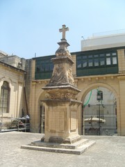 Fototapeta na wymiar Malta La Valletta monument with skulls and cross in inner courtyard