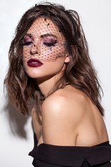 Elegant luxury brunette model with professional make up, violet smoky eyes, marsala glossy lips and...