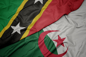 waving colorful flag of algeria and national flag of saint kitts and nevis.