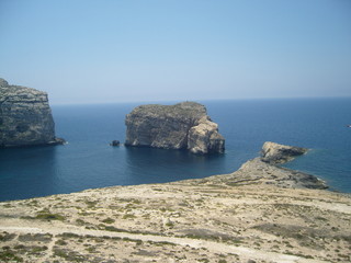 Fototapeta na wymiar Malta island Gozo steep rocky shore and mediterranean sea in summer