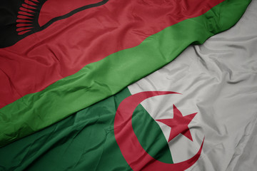 waving colorful flag of algeria and national flag of malawi.