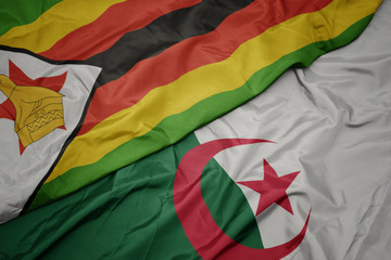 waving colorful flag of algeria and national flag of zimbabwe.