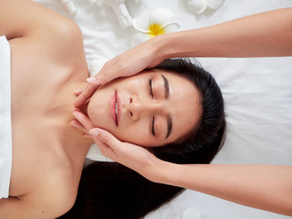 Obraz na płótnie Canvas Beautiful woman receiving facial massage in spa.