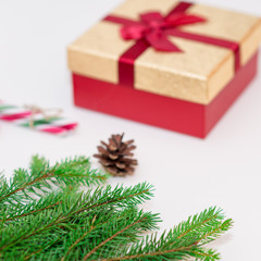 Fototapeta na wymiar Christmas concept, gifts box, branches,fir cone and candy canes against a white background.