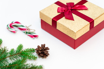 Christmas concept, gifts box, branches,fir cone and candy canes against a white background.