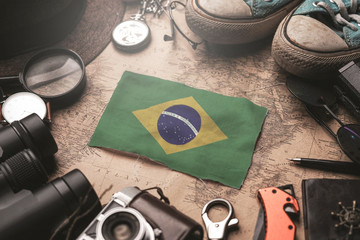 Brazil Flag Between Traveler's Accessories on Old Vintage Map. Tourist Destination Concept.