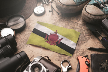 Brunei Flag Between Traveler's Accessories on Old Vintage Map. Tourist Destination Concept.