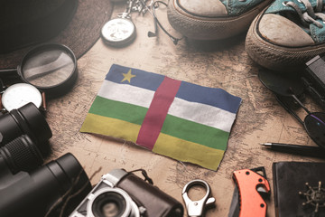 Central African Republic Flag Between Traveler's Accessories on Old Vintage Map. Tourist...