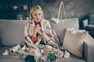 Photo of unhealthy pretty blond lady suffering flu caught cold paper napkins everywhere hold...