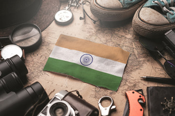 India Flag Between Traveler's Accessories on Old Vintage Map. Tourist Destination Concept.