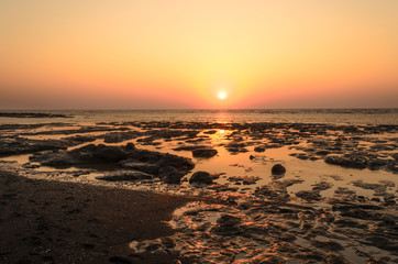 Obraz na płótnie Canvas Sunset on Rocky -Devaka Beach Daman India. During Low tide