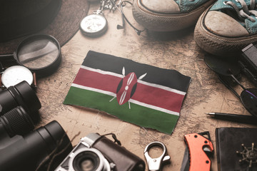 Kenya Flag Between Traveler's Accessories on Old Vintage Map. Tourist Destination Concept.